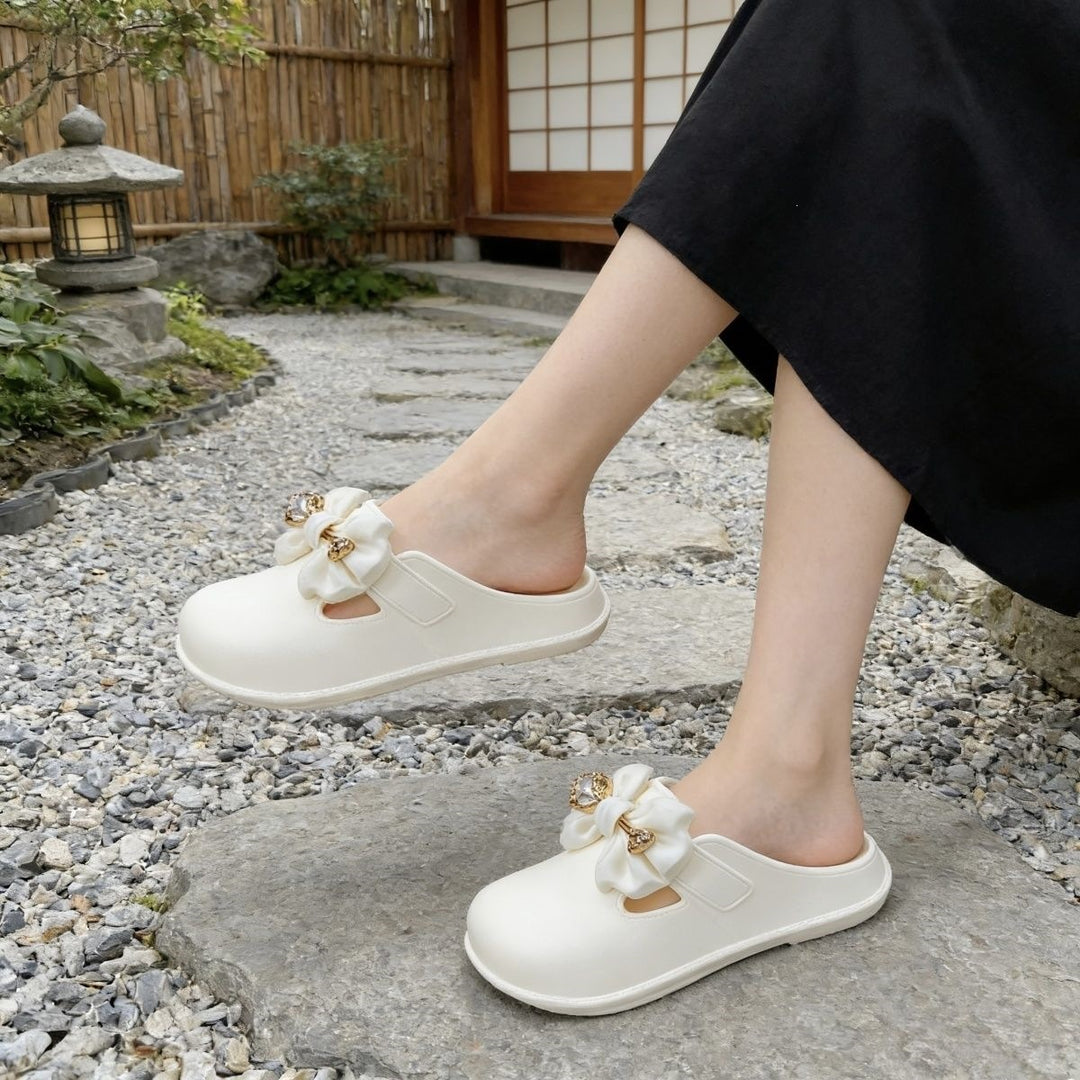 Bow-embellished closed-toe, open-back mules