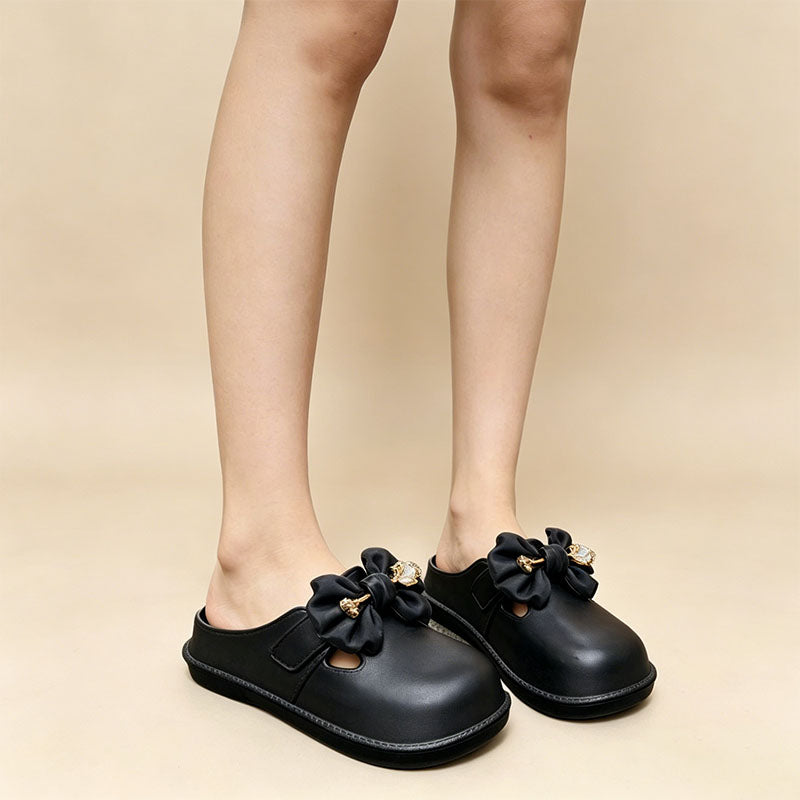 Bow-embellished closed-toe, open-back mules