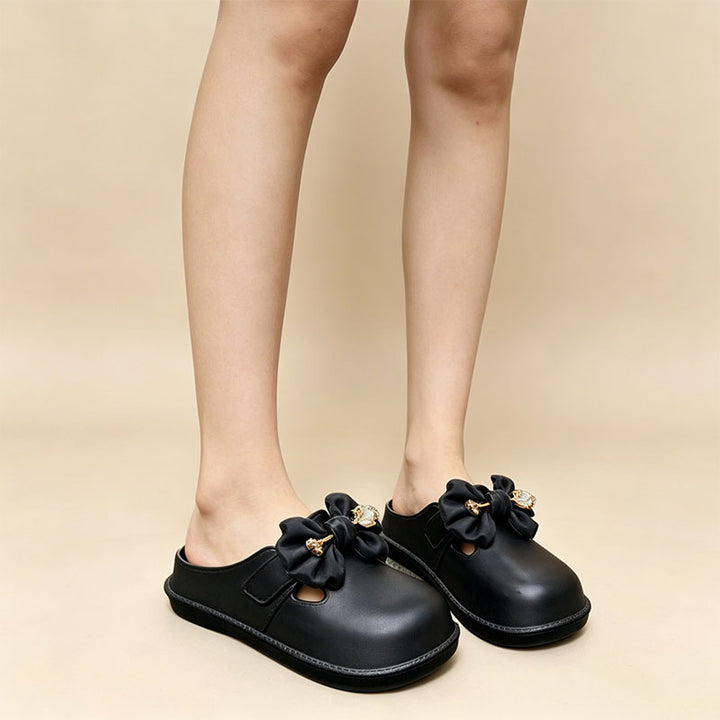 Bow-embellished closed-toe, open-back mules